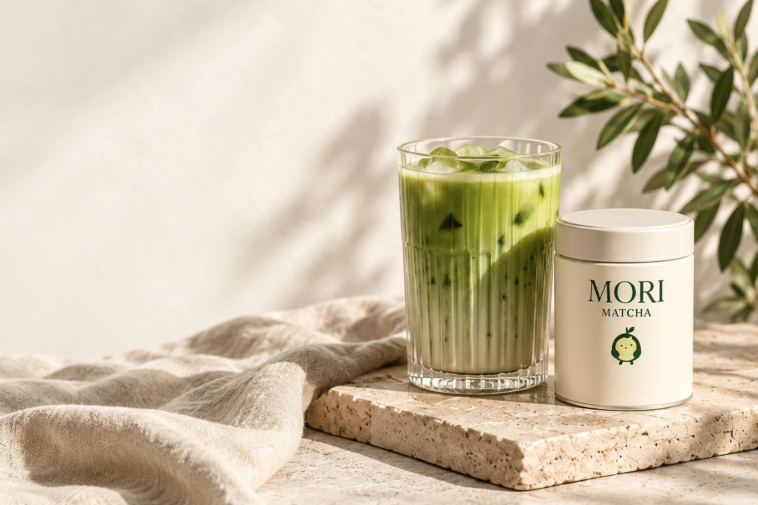 Iced matcha and Mori Matcha on sunlit stone